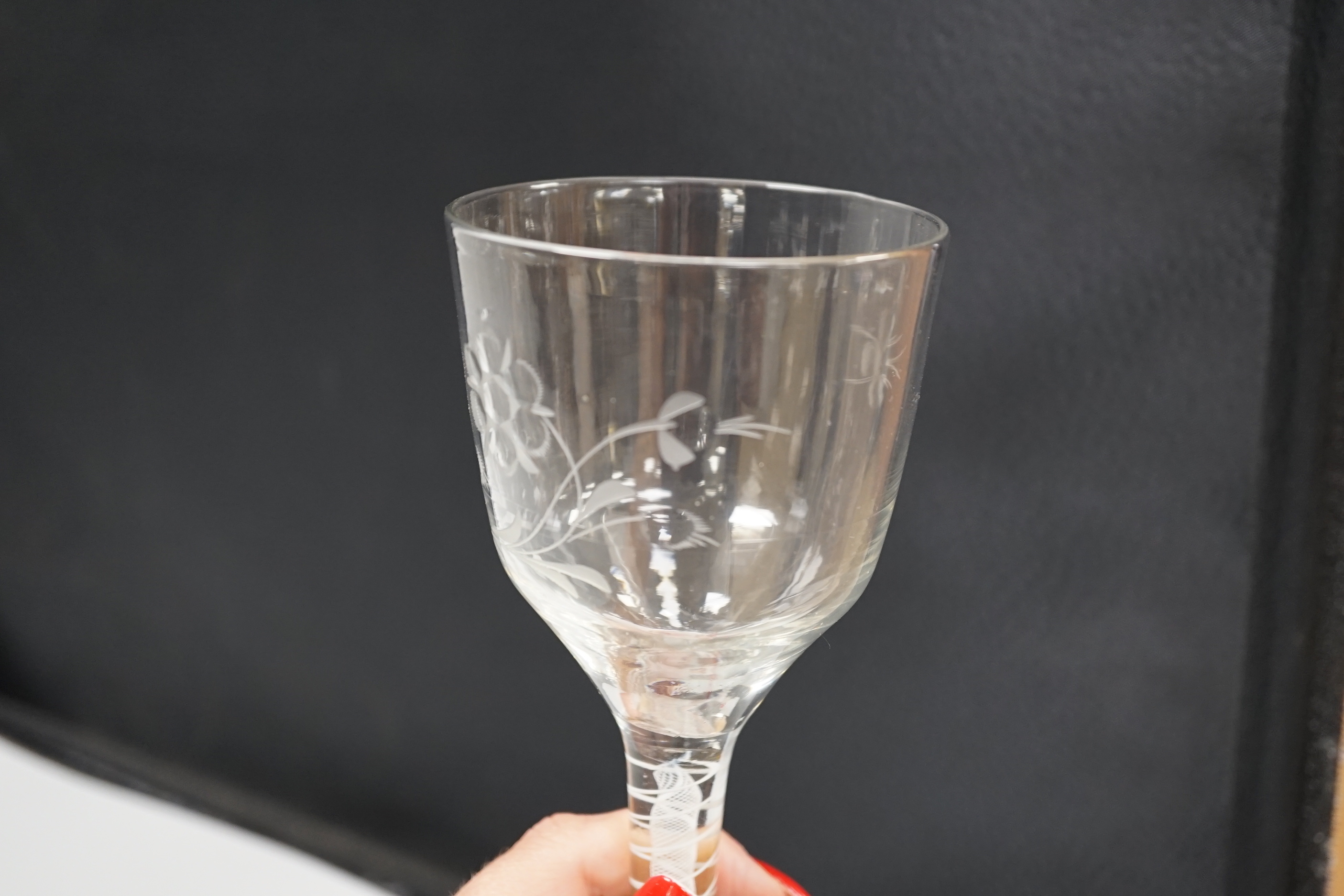 An English lead crystal DSOT goblet, c.1760, ogee bowl with tool marks and engraved with polished flora opposite a single insect which appears to be a bee, two spiral tapes around a gauze, conical foot, broken pontil, 18